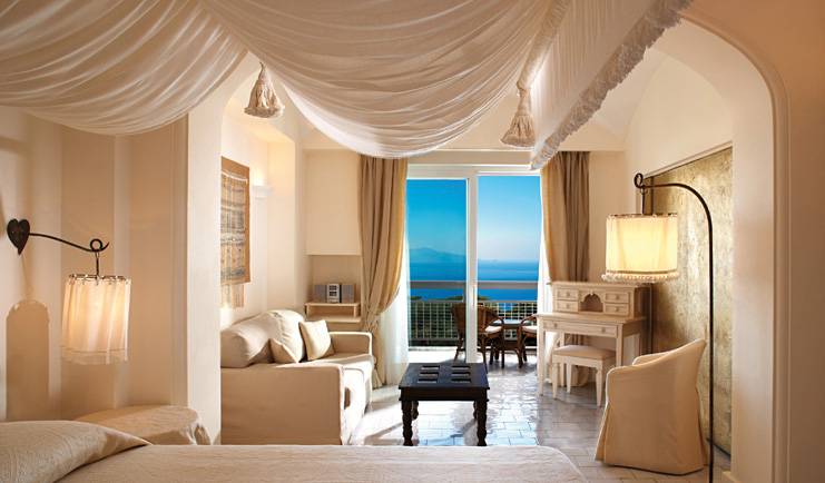 Capri Palace Hotel Amalfi Coast deluxe suite canopied bed sofa terrace elegant décor