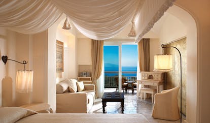 Capri Palace Hotel Amalfi Coast deluxe suite canopied bed sofa terrace elegant décor