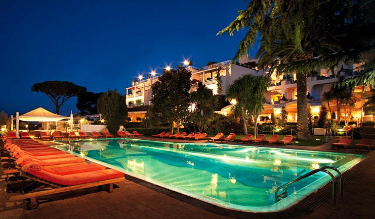 Capri Palace Hotel Amalfi Coast pool at night sun loungers hotel in background