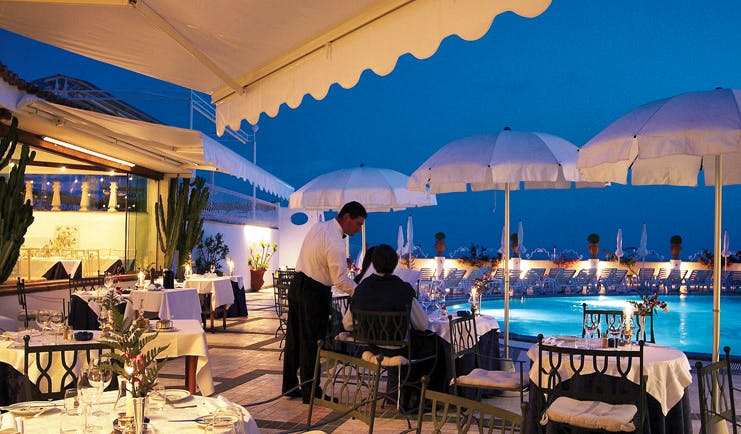 Hotel Quisisana Capri poolside dining tables umbrellas waiter