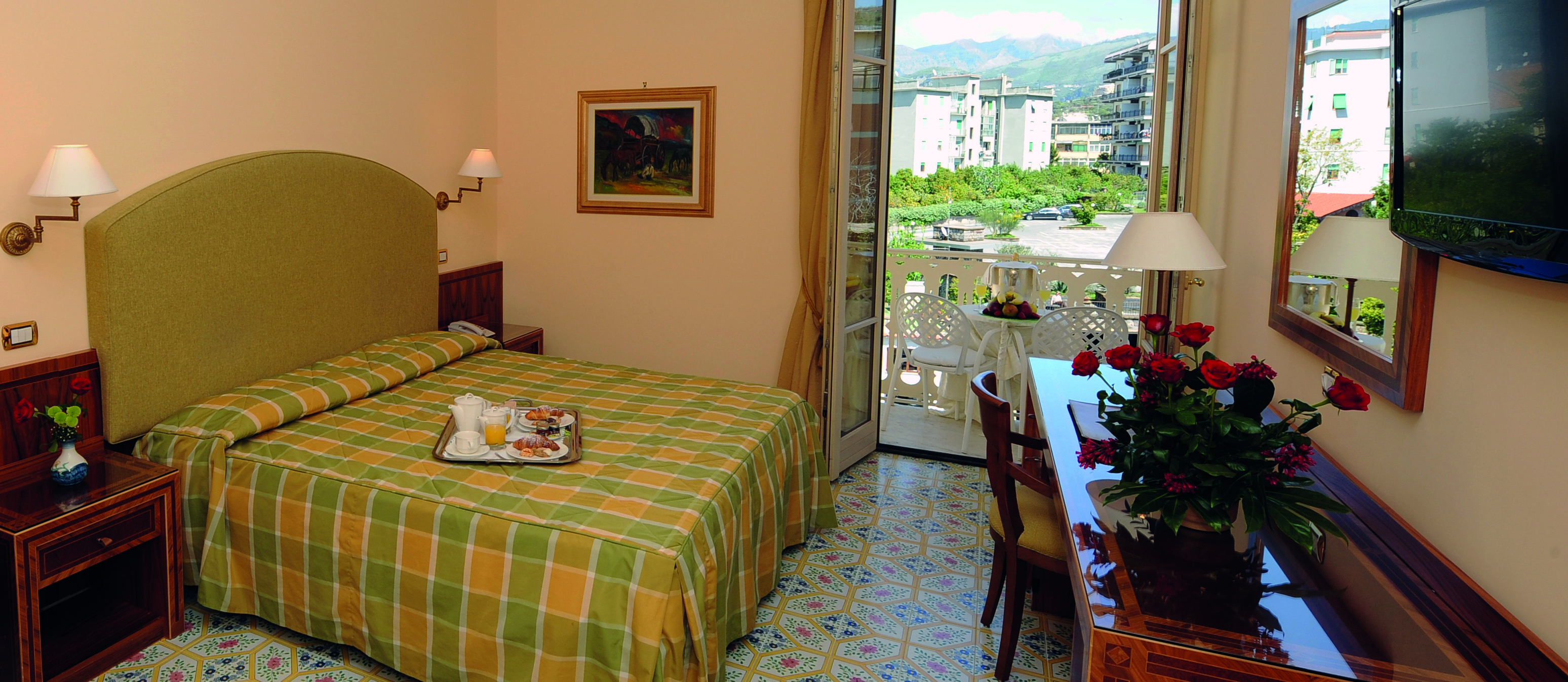 Hotel Antiche Mura Amalfi Coast comfort room double bed doors leading to balcony with table and chairs