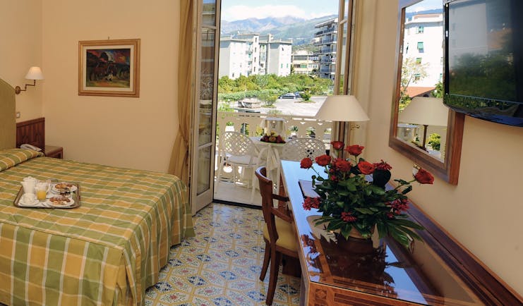 Hotel Antiche Mura Amalfi Coast comfort room double bed doors leading to balcony with table and chairs