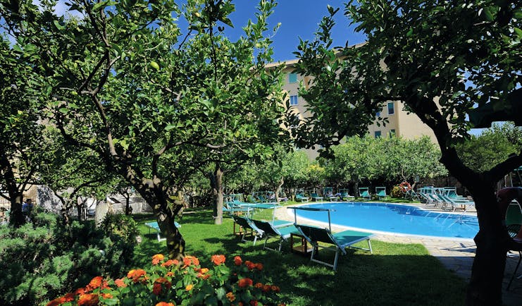 Hotel Antiche Mura Amalfi Coast pool sun loungers in citrus garden