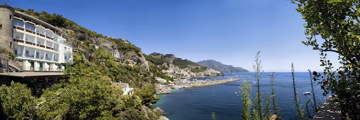 Hotel Miramalfi Amalfi Coast exterior building nestled into cliffside overlooking sea