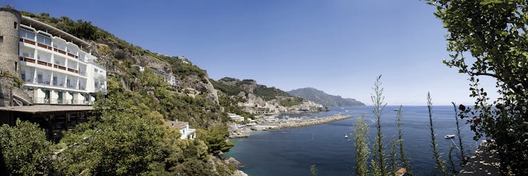Hotel Miramalfi Amalfi Coast exterior building nestled into cliffside overlooking sea
