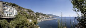 Hotel Miramalfi Amalfi Coast exterior building nestled into cliffside overlooking sea
