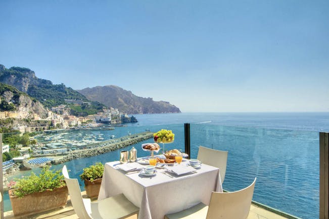 Hotel Miramalfi Amalfi Coast restaurant outdoor dining terrace glass walls sea views