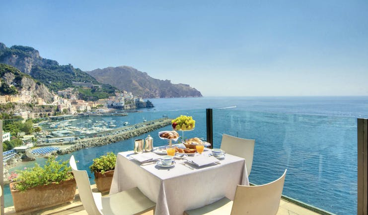 Hotel Miramalfi Amalfi Coast restaurant outdoor dining terrace glass walls sea views