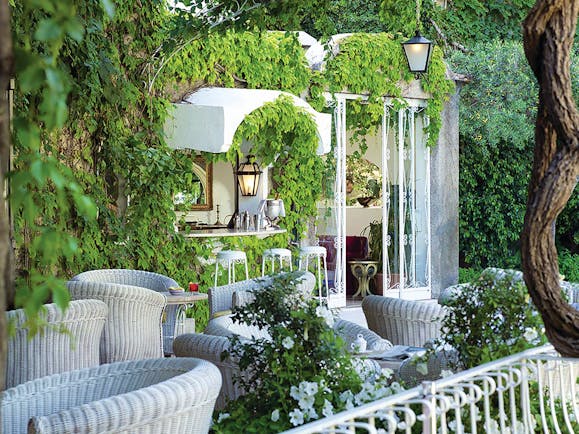 Hotel Poseidon Amalfi Coast bar indoor and outdoor seating building covered with leaves