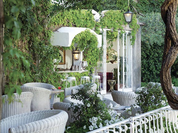 Hotel Poseidon Amalfi Coast bar indoor and outdoor seating building covered with leaves