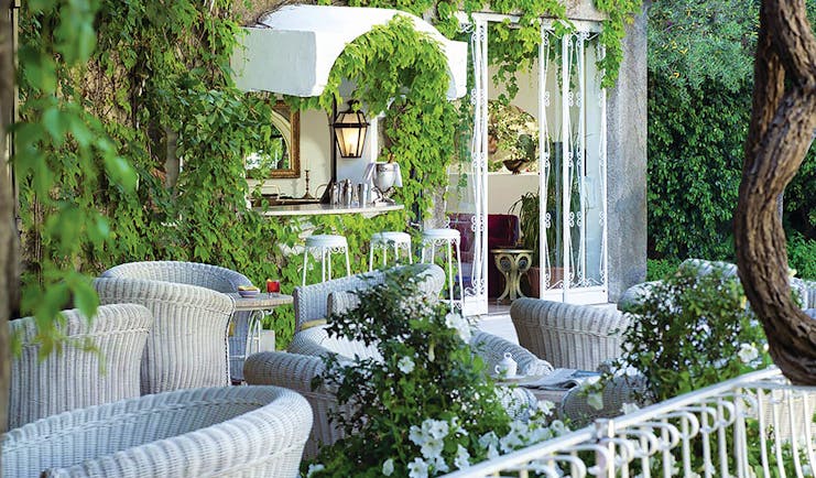 Hotel Poseidon Amalfi Coast bar indoor and outdoor seating building covered with leaves