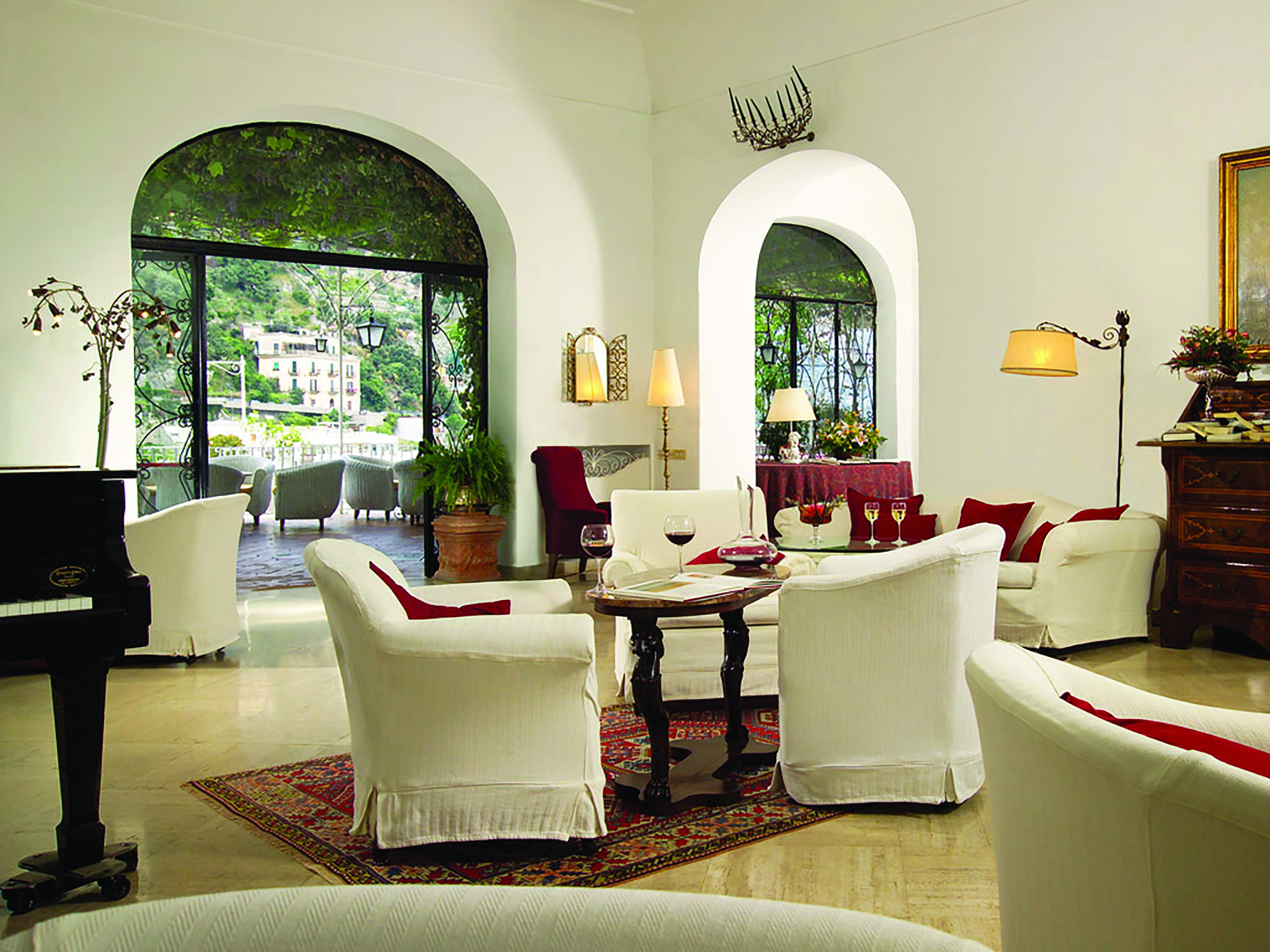 Hotel Poseidon Amalfi Coast indoor seating piano doors leading to outdoor terrace seating