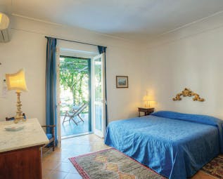 Hotel Poseidon Amalfi Coast superior junior suite bedroom doors leading to outdoor seating area balcony