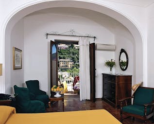 Hotel Poseidon Amalfi Coast superior suite lounge indoor seating area leading to balcony