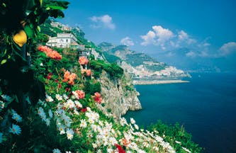 Hotel Santa Caterina Amalfi Coast exterior cliffside view hotel and coastline flowers in foreground