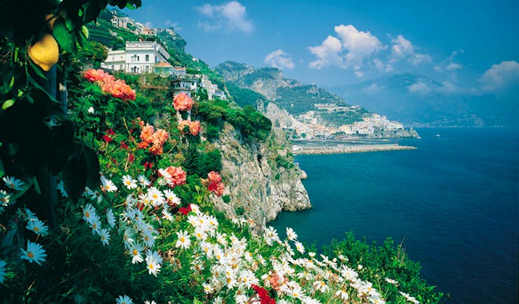 Hotel Santa Caterina Amalfi Coast exterior cliffside view hotel and coastline flowers in foreground
