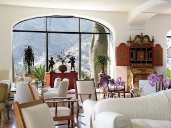 Il San Pietro di Positano lobby with white sofas and potted plants around the room