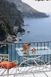 View from a terrace at the Il San Pietro Di Positano looking over mountains and the ocean