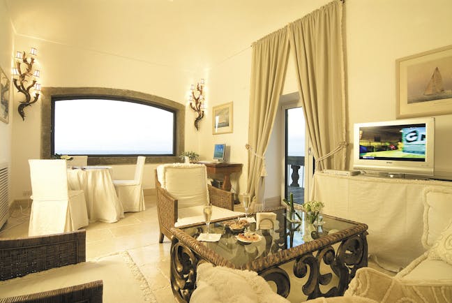 Mezzatorre Resort Amalfi Coast suite lounge area sofas chairs coffee table television