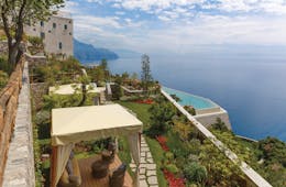 Monastero Santa Rosa Amalfi Coast gardens view of pool and ocean cabanas on lawn
