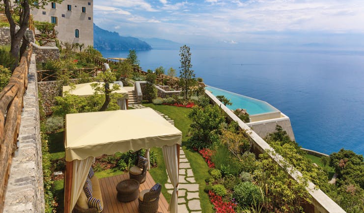 Monastero Santa Rosa Amalfi Coast gardens view of pool and ocean cabanas on lawn