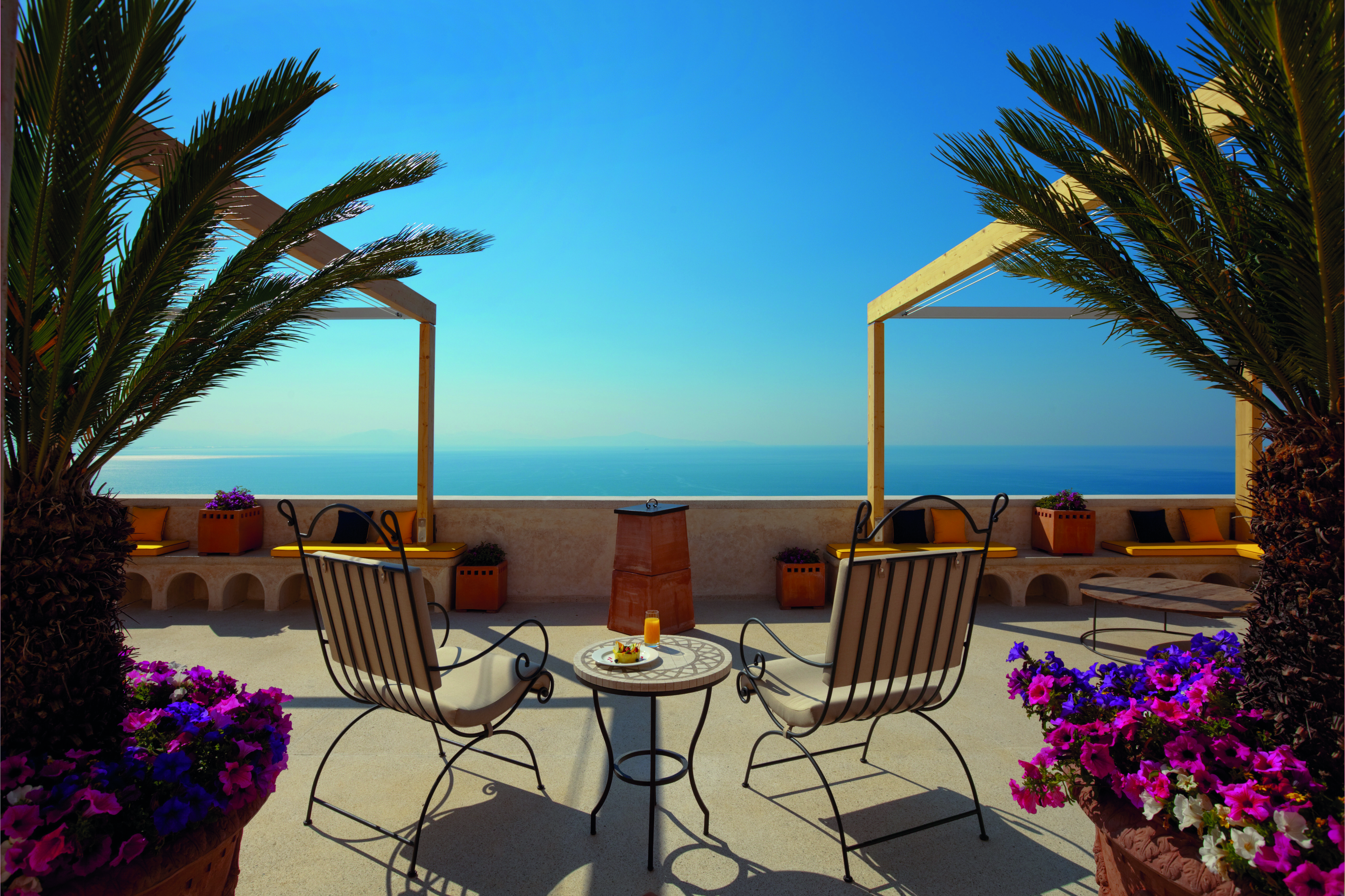 Monastero Santa Rosa Amalfi Coast sunset terrace outdoor seating area overlooking the sea flowers in plant pots