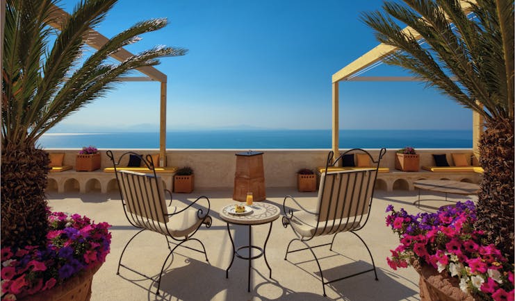 Monastero Santa Rosa Amalfi Coast sunset terrace outdoor seating area overlooking the sea flowers in plant pots