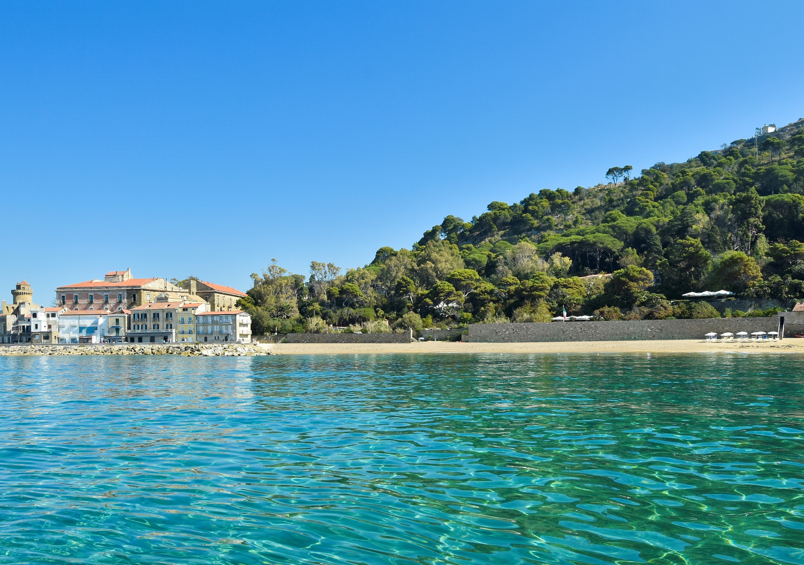 Turquoise sea and grand palazzo building on the shore