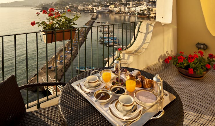 Regina Isabella balcony, breakfast served on sun drenched balcony, overlooking sea and hotel beach club, town and mountains in background