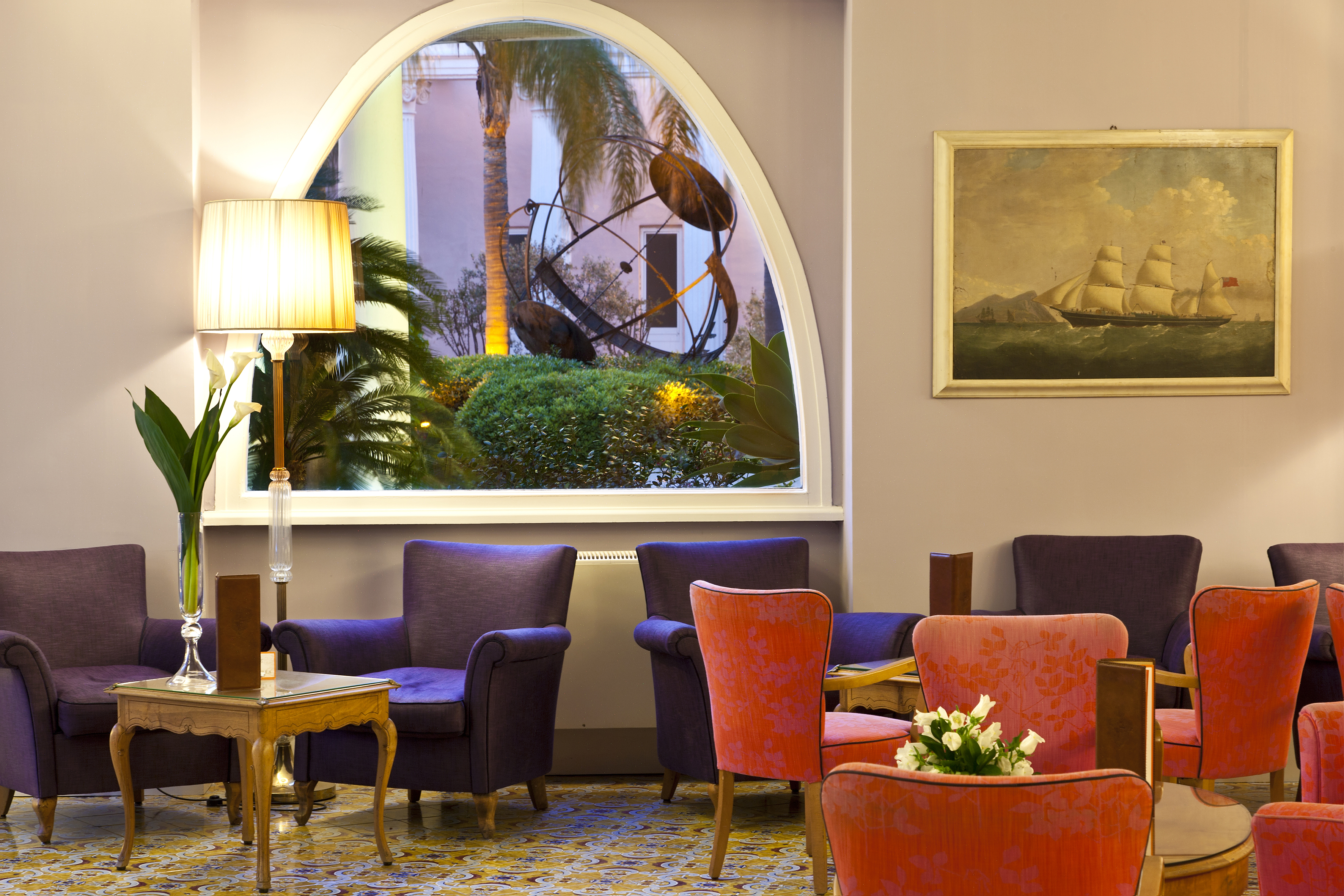 Regina Isabella bar, leather armchairs, little tables, colourful elegant decor, window, painting