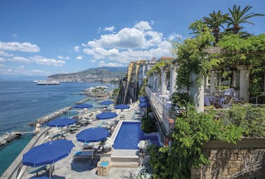 Bellevue Syrene Amalfi Coast pool terrace sun loungers umbrellas ocean coastline in background