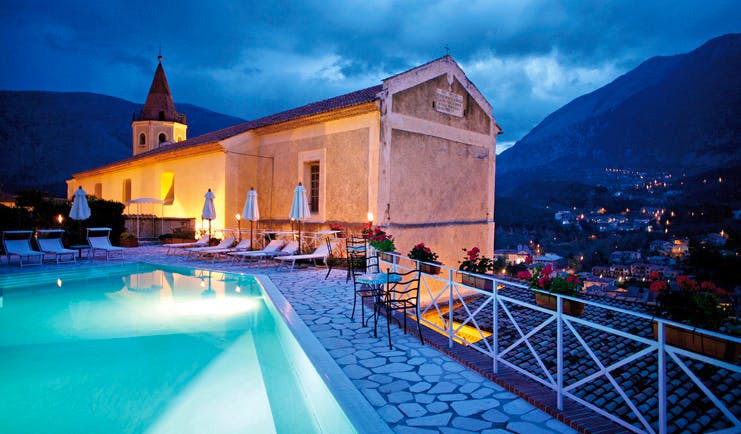 La Locanda Delle Donne Monache Basilicata exterior at night hotel building pool mountains in background