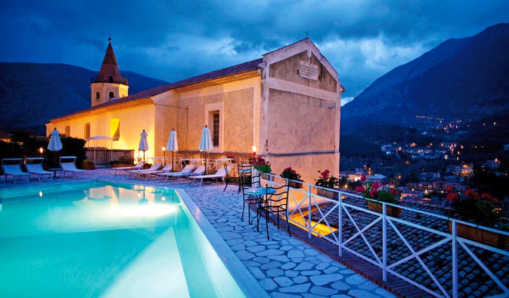 La Locanda Delle Donne Monache Basilicata exterior at night hotel building pool mountains in background