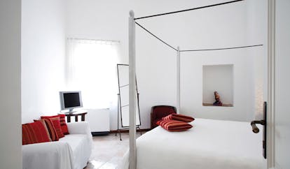 La Locanda Delle Donne Monache Basilicata suite interior four poster bed sofa modern décor