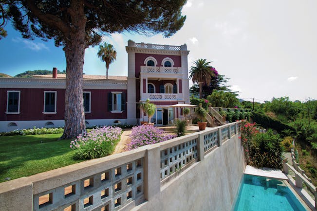 Villa Paola Calabria exterior gardens tree and pink flowers