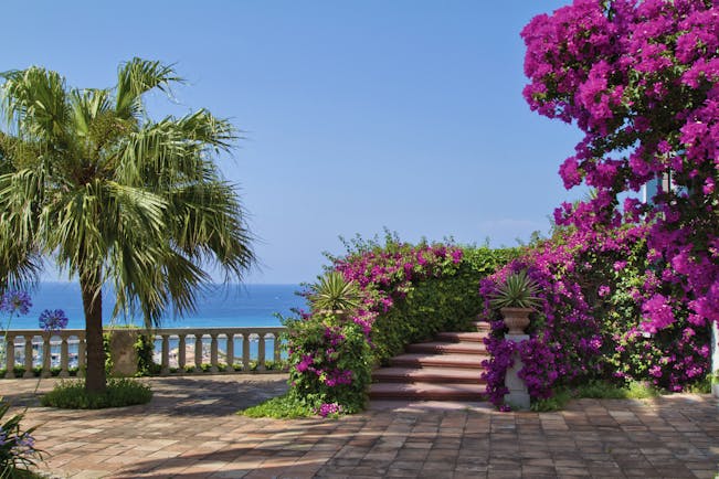 Villa Paola Calabria gardens trees pink flowers views of the sea