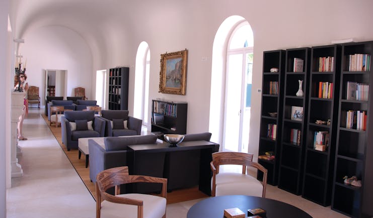 Villa Paola Calabria lounge library indoor seating area sofas bookshelves