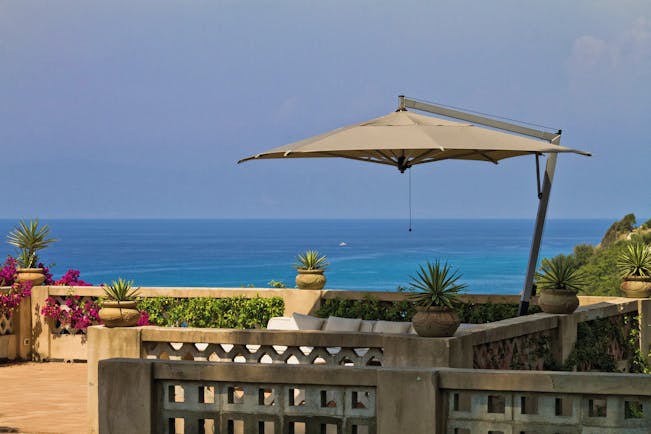 Villa Paola Calabria sun terrace outdoor seating and umbrella overlooking the sea