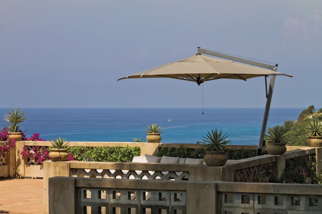 Villa Paola Calabria sun terrace outdoor seating and umbrella overlooking the sea