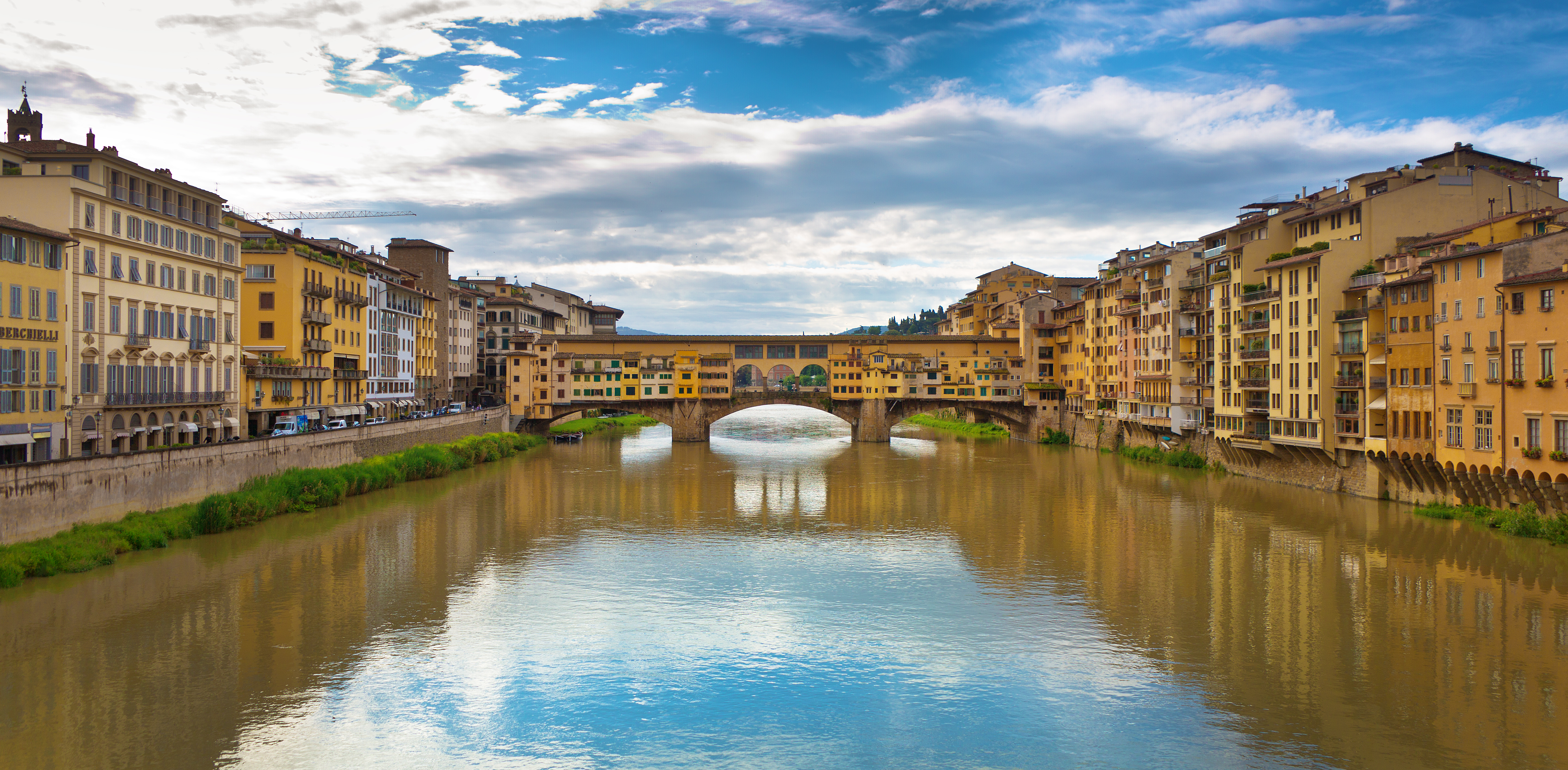 The river Arno with covered bridge Ponte Vecchio joining the two sides of the river in Florence