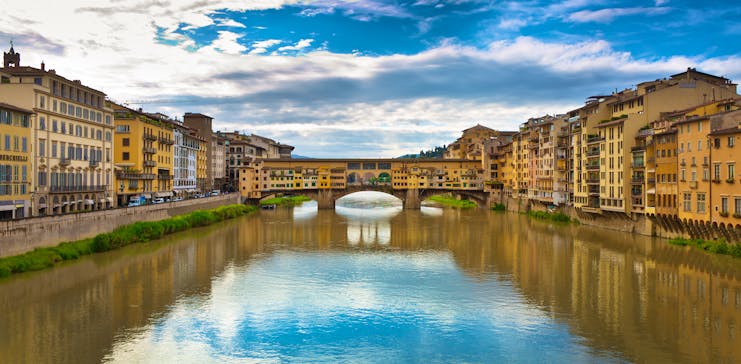 The river Arno with covered bridge Ponte Vecchio joining the two sides of the river in Florence