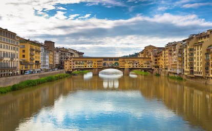 The river Arno with covered bridge Ponte Vecchio joining the two sides of the river in Florence