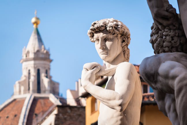 Statue of David with the terracotta cupola of the cathedral in Florence