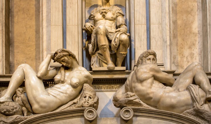 Michelangelo's sculptures of night and day on the marble tomb of Giuliano de Medici in Florence