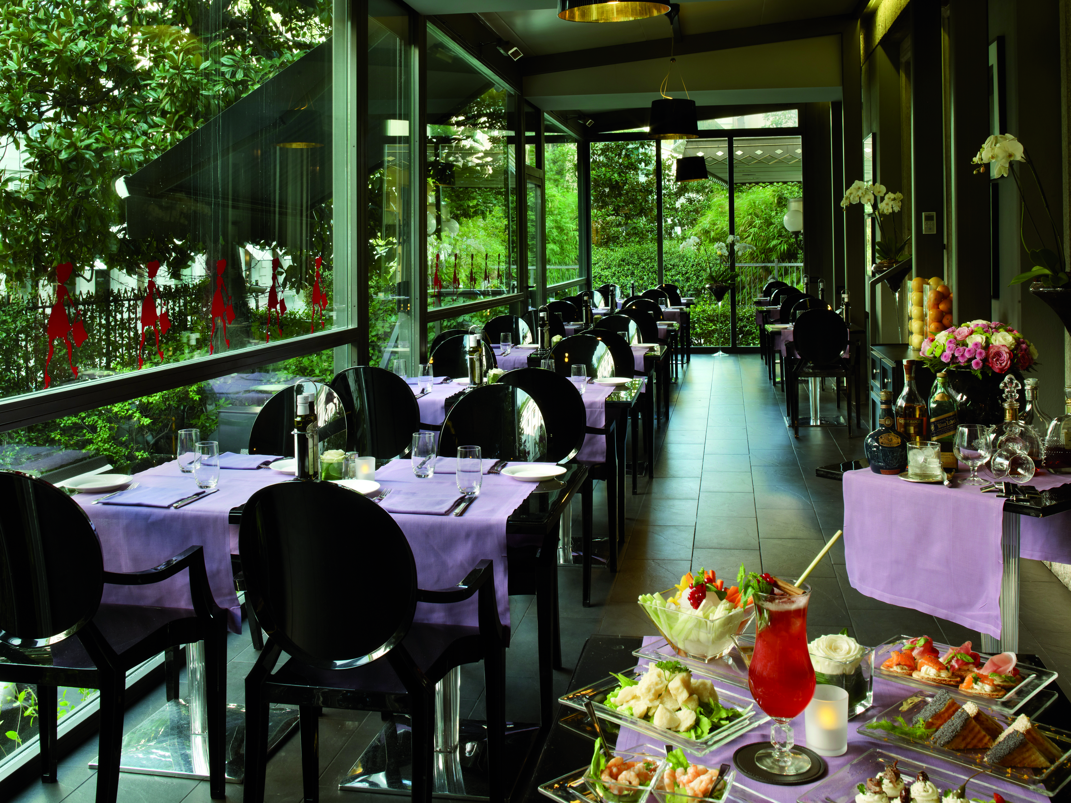 Dining area at the caffe e terrazza baglioni restaurant with black seats and black tables covered with pink table cloths