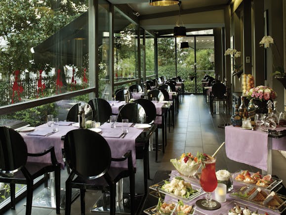 Dining area at the caffe e terrazza baglioni restaurant with black seats and black tables covered with pink table cloths