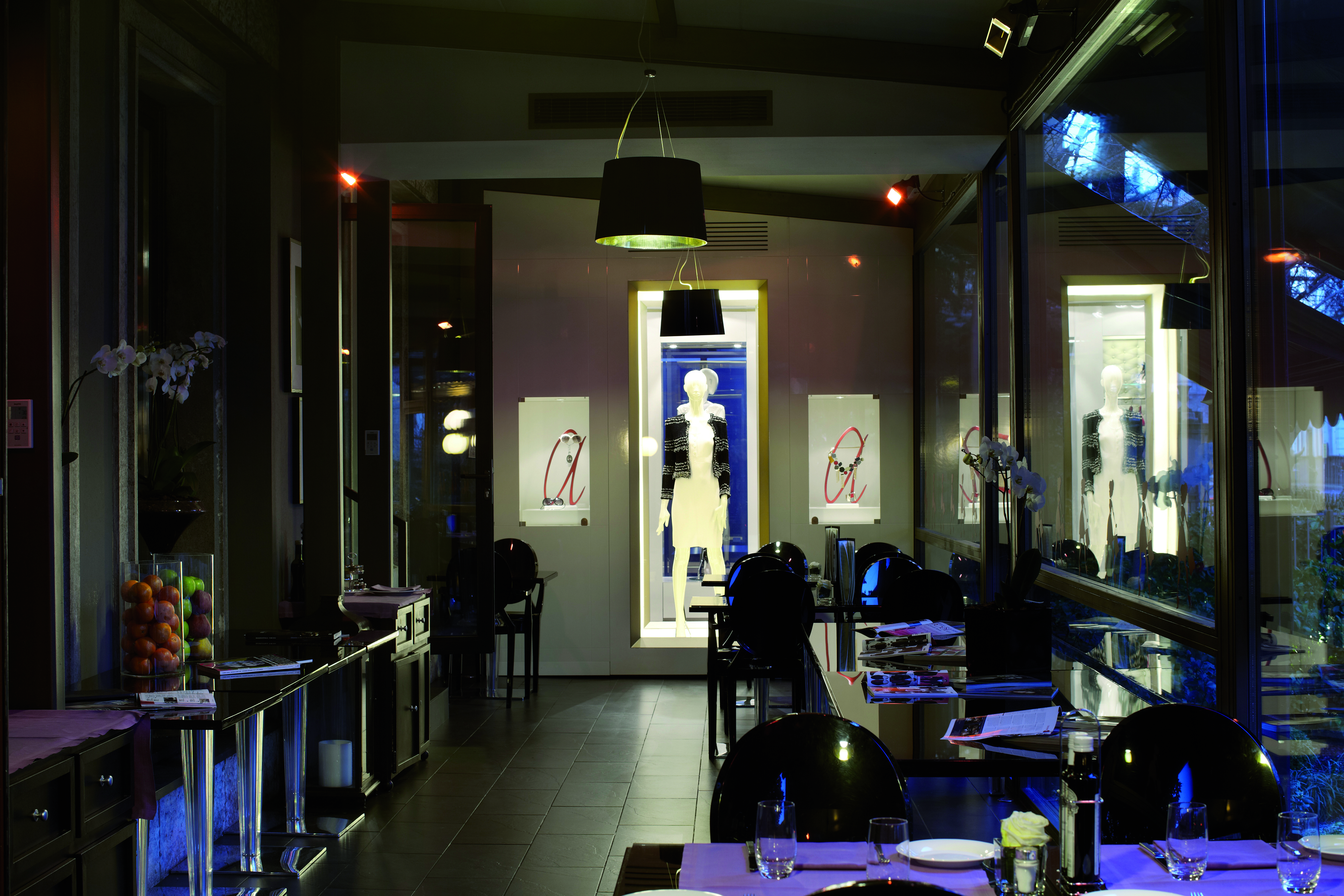 Dining area in the Baglioni Hotel Carlton with black dining tables with purple table cloths and art work on the walls