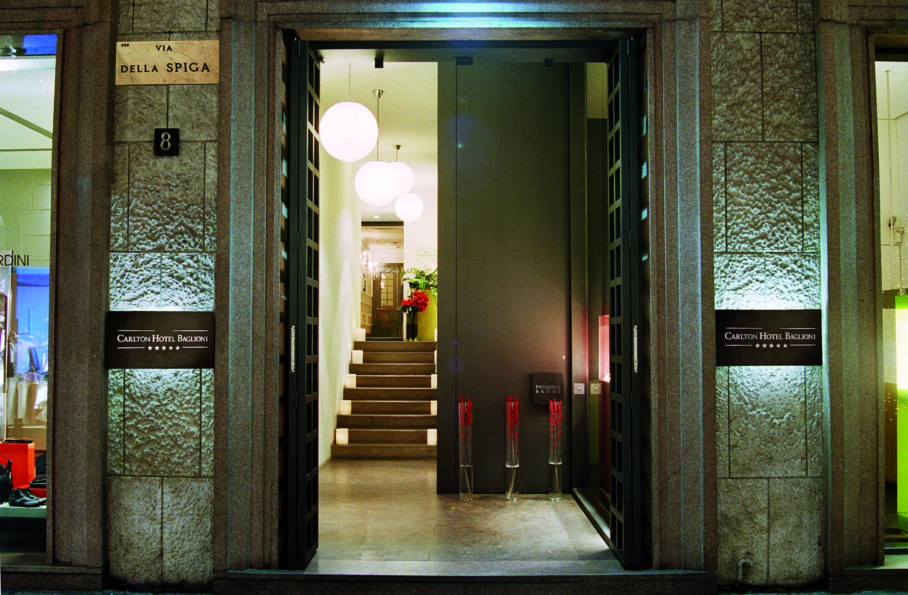 Front on view of the entrance to the hotel, showing the open doors leading up to a small wooden staircase