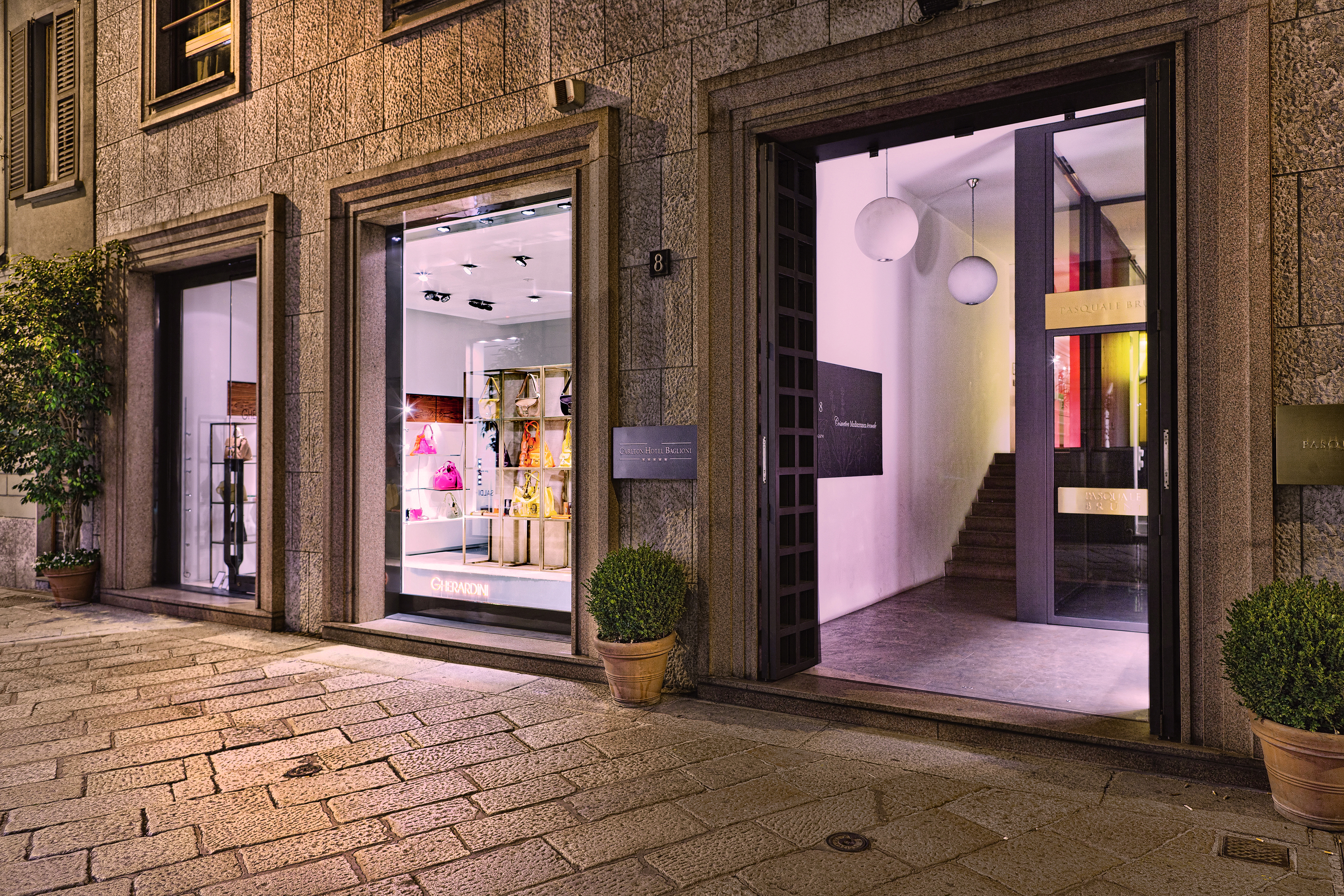 Entrance to the Baglioni Hotel Carlton with big windows shown on the side of the hotel