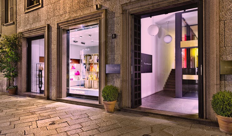 Entrance to the Baglioni Hotel Carlton with big windows shown on the side of the hotel